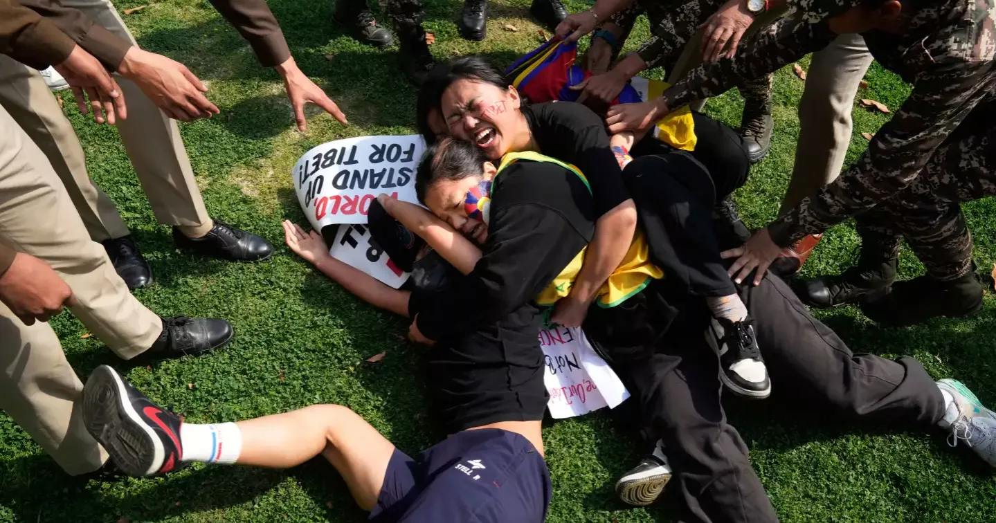 Tibetans scuffle with police outside the Chinese Embassy in India as they mark uprising anniversary