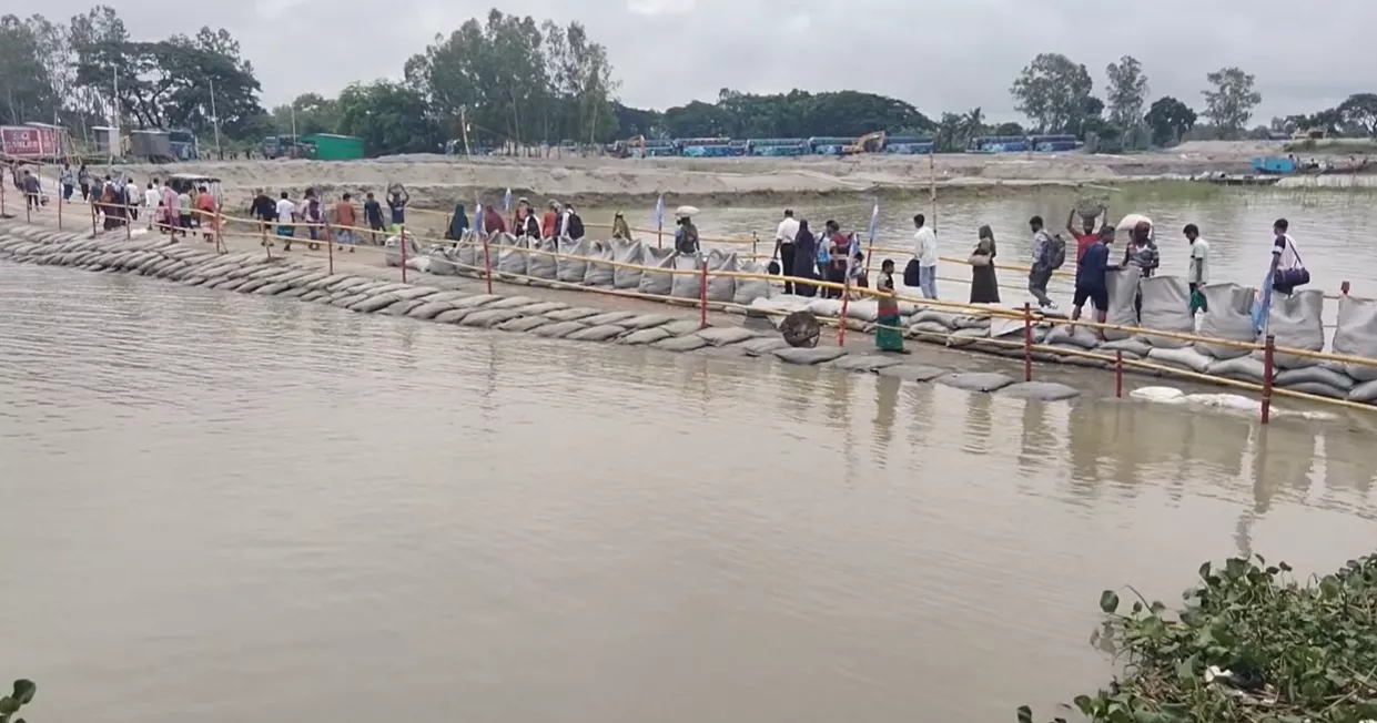 Rising Padma water floods Paturia Launch Ghat access road