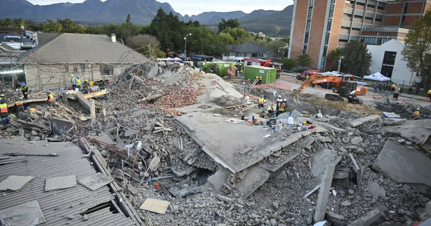Rescuers contact some workers alive in the rubble of a deadly building collapse in South Africa