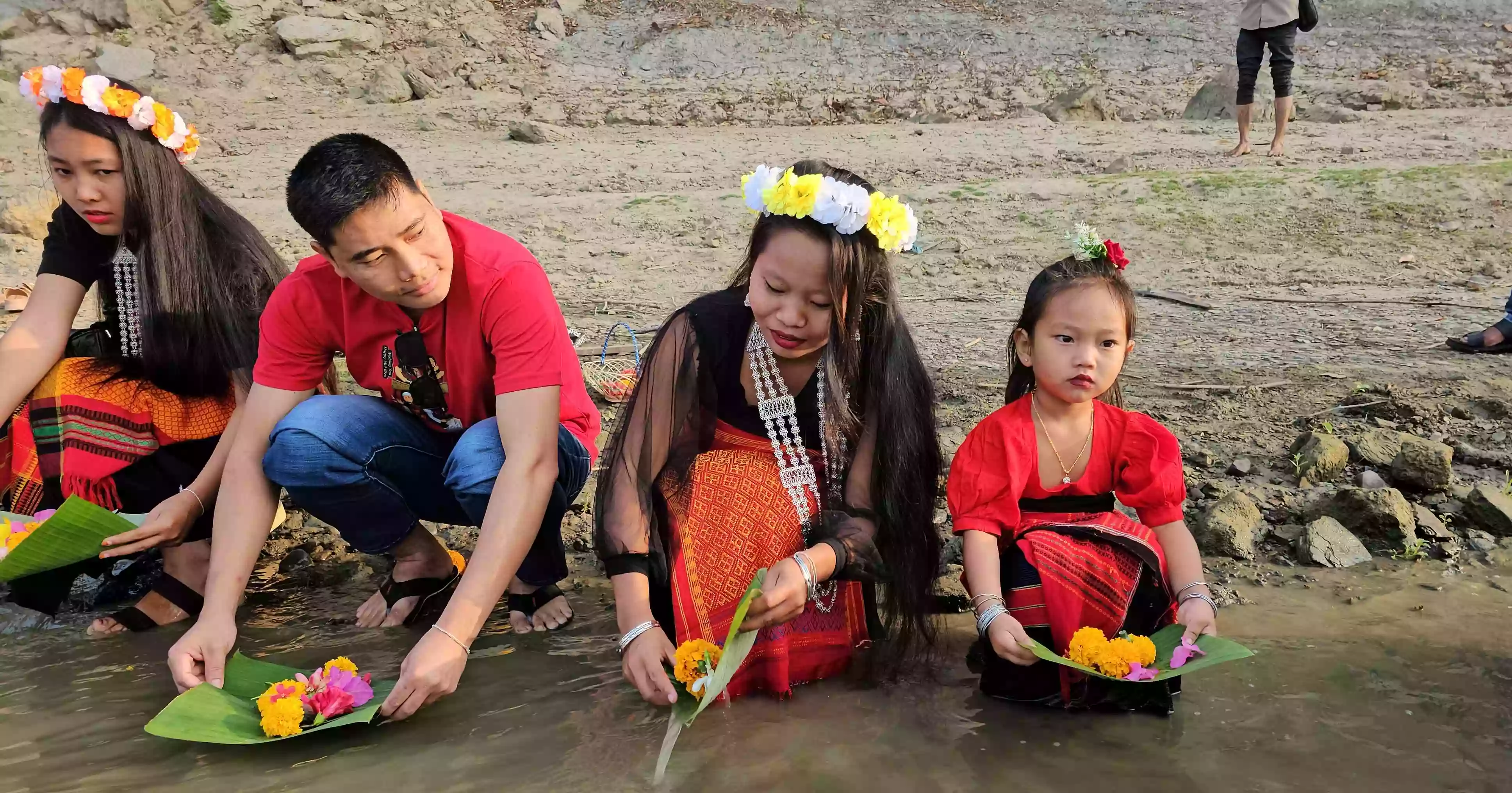 Biju, Bishu festivals begin in Bandarban with flower offerings in river