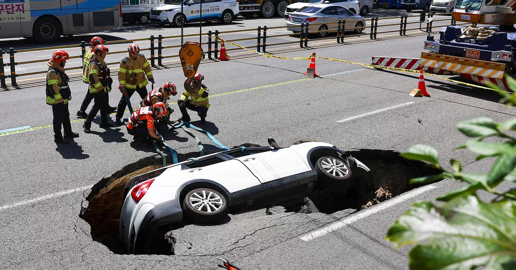 A sinkhole swallows an SUV in South Korea, injuring 2 people