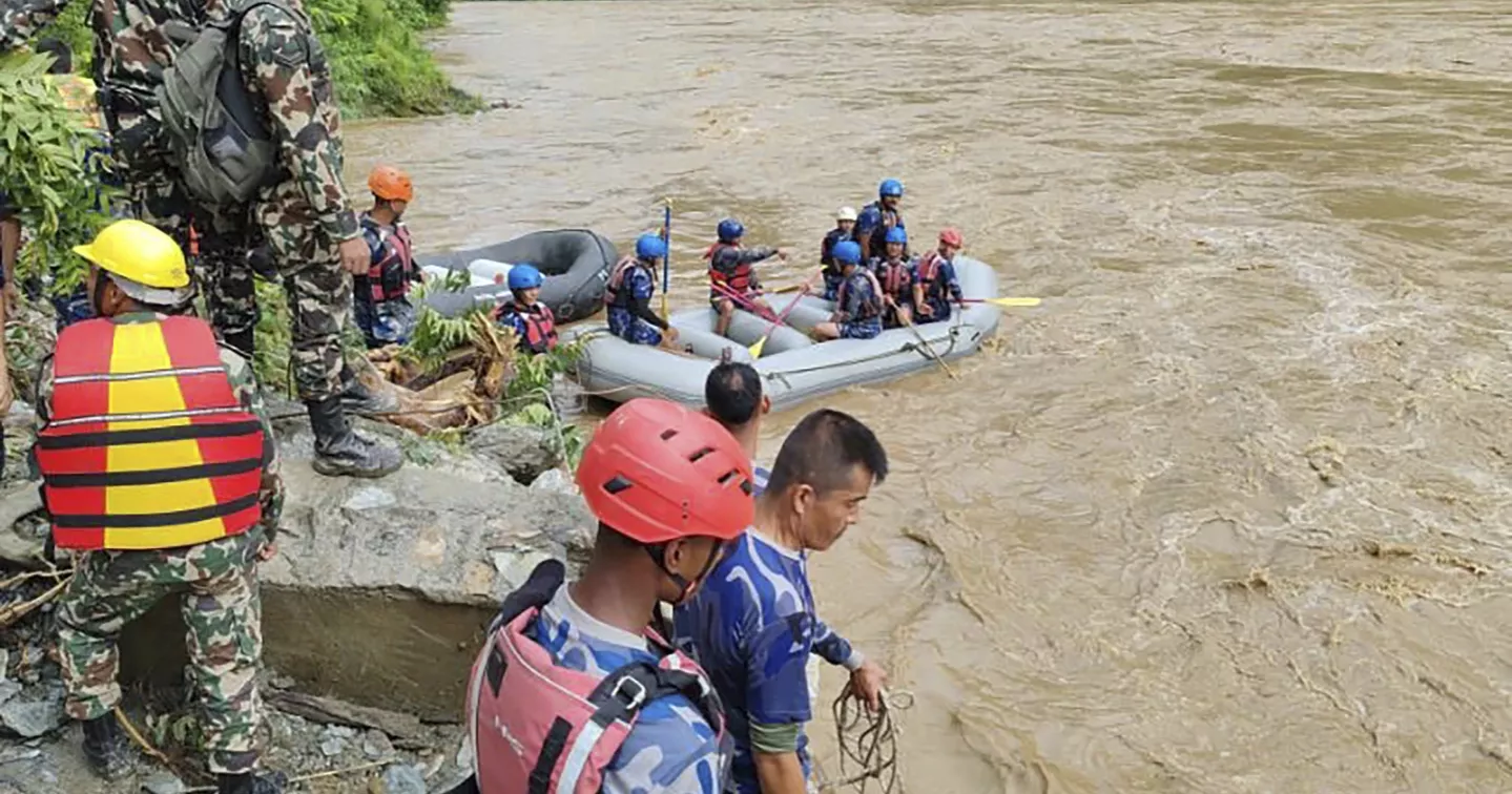 Rescuers in Nepal search for 2 buses with more than 50 people on board that was swept into a river