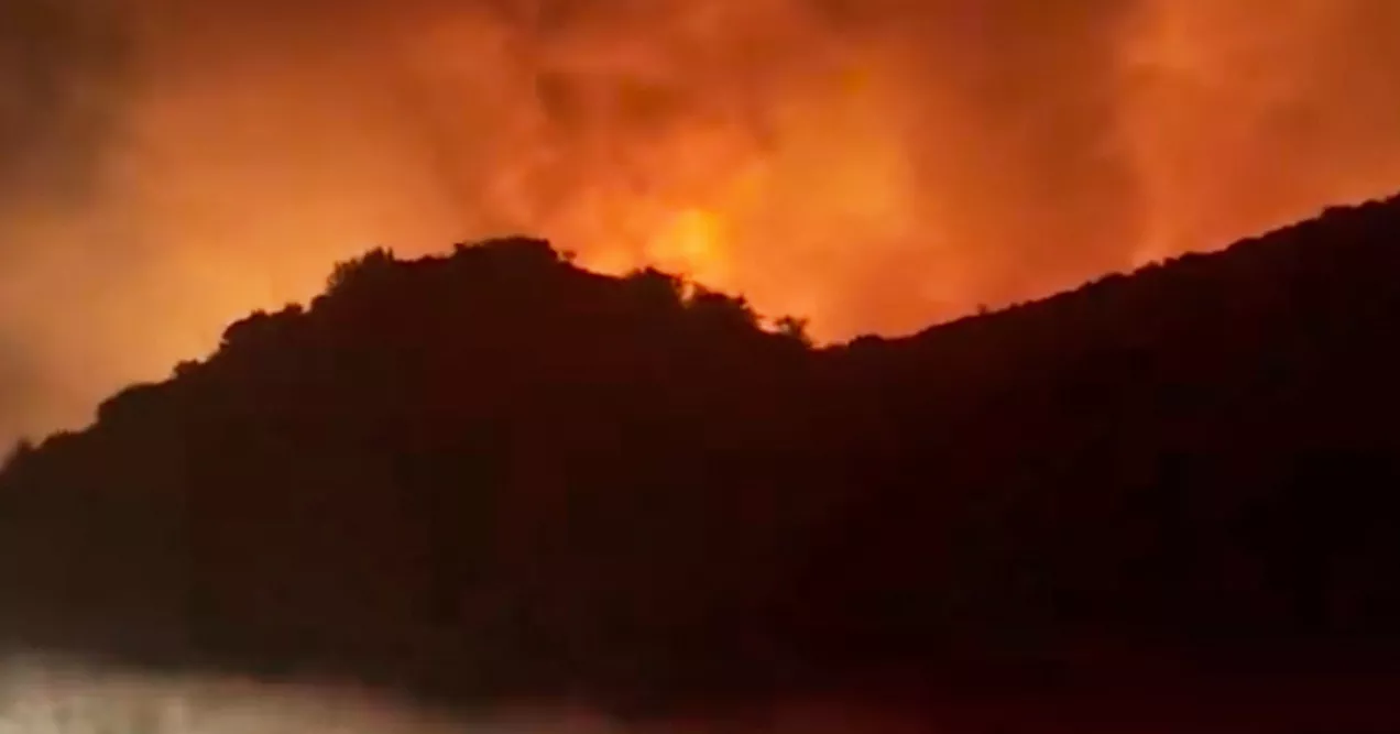 Firefighters struggle to contain wildfire near L.A. suburbs