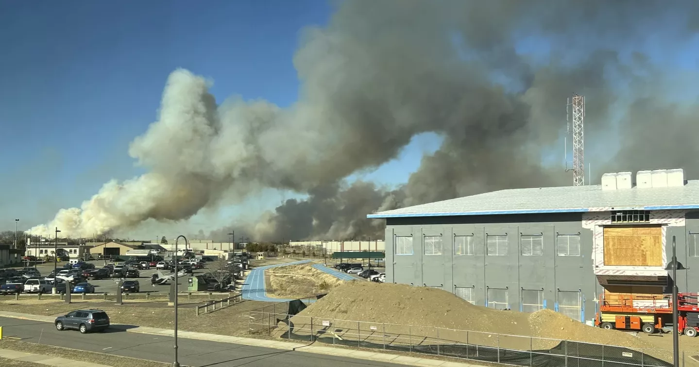 Wind-driven brush fire on New York's Long Island 50 percent contained. Firefighter injured