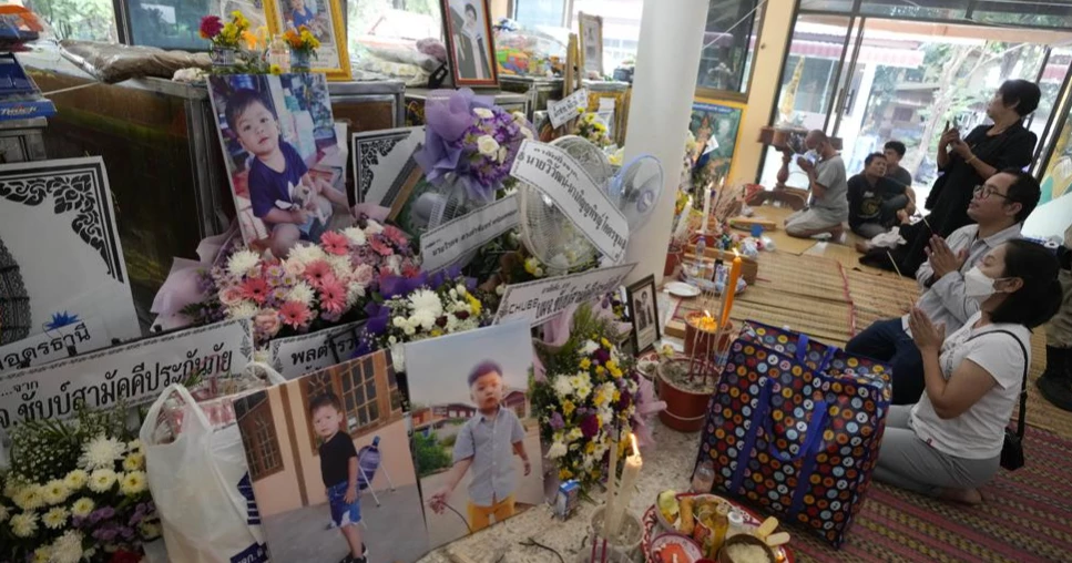 Grief-stricken families of children killed at daycare pray in Thai temple