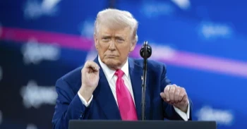 Trump revels in mass federal firings and jeers at Biden before adoring conservative crowd