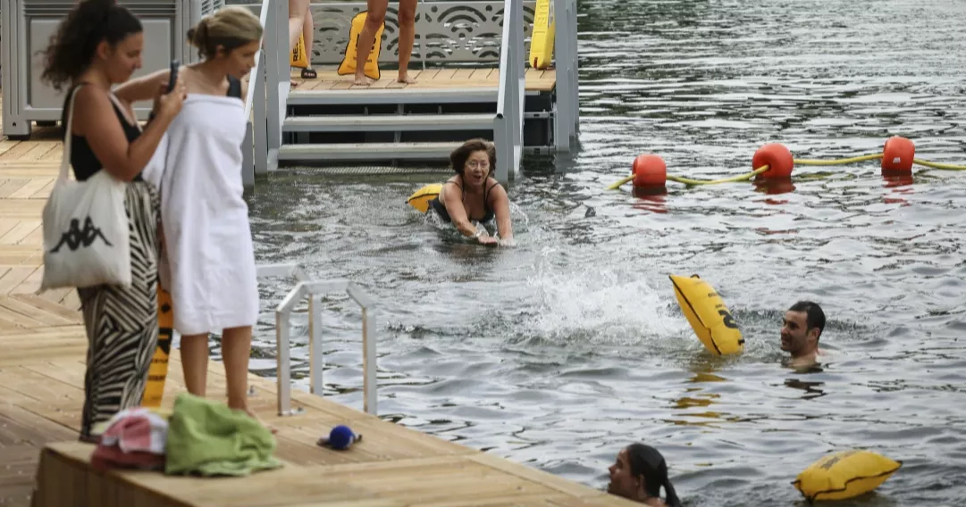 Joyful Parisians take a historic plunge into the Seine after 100 years
