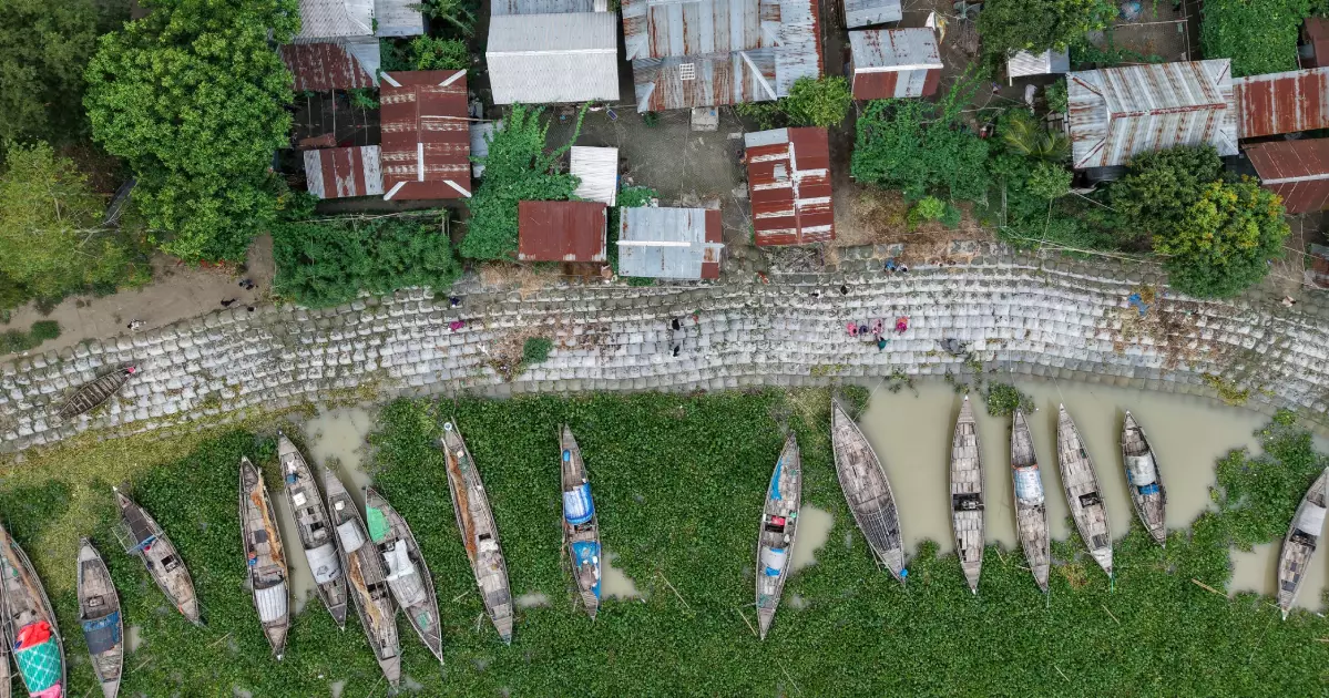 As rivers swallow villages, one wooden house keeps hope afloat